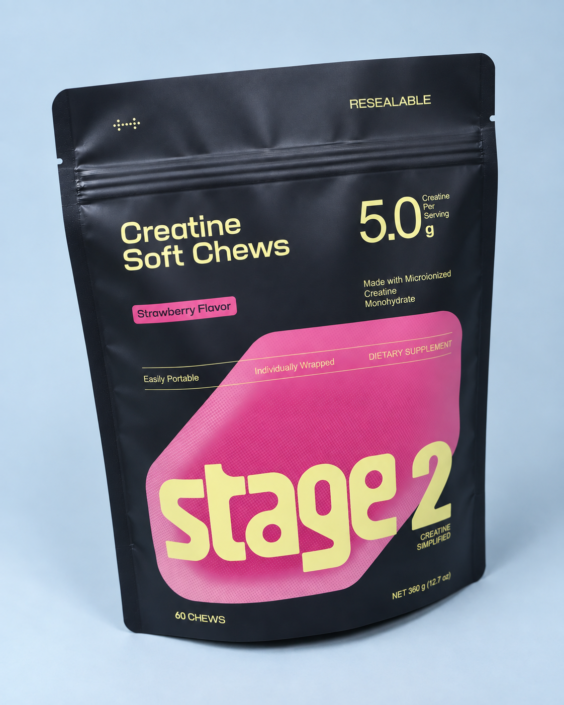 Close-up of the Stage 2 strawberry creatine soft chews pouch in soft pale-blue light